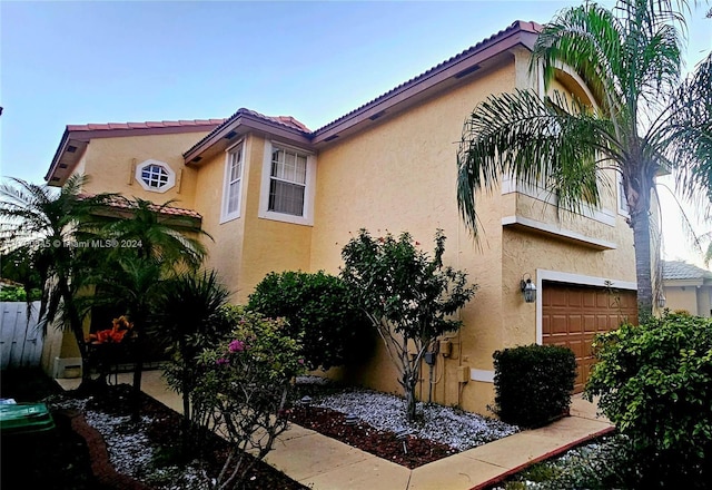 17352 SW 18th St, Miramar, FL 33029 - view of side of home featuring stucco siding, a garage, and a tiled roof