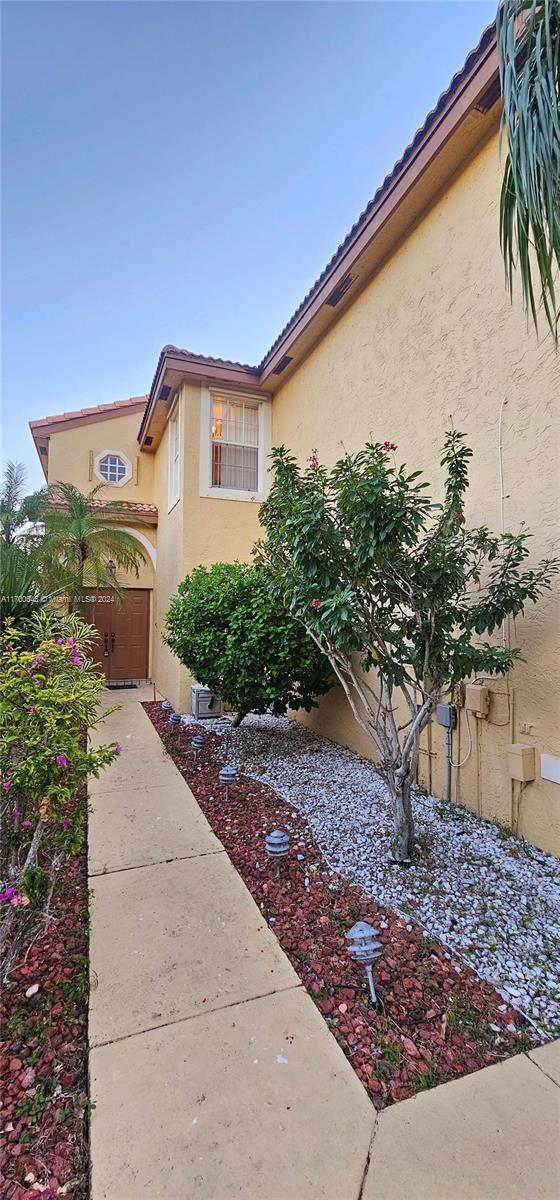 17352 SW 18th St, Miramar, FL 33029 - view of home's exterior featuring stucco siding and a tiled roof