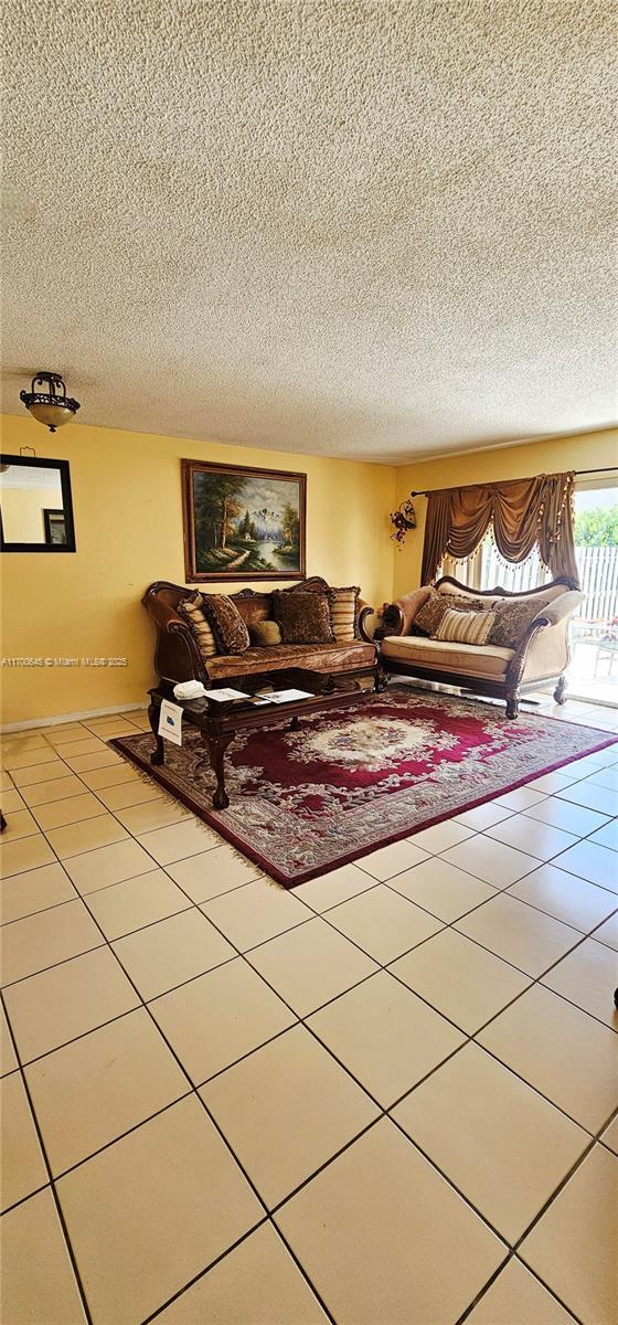 17352 SW 18th St, Miramar, FL 33029 - living area featuring tile patterned floors and a textured ceiling