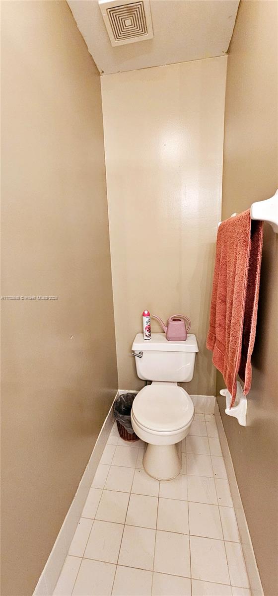 bathroom featuring tile patterned flooring and toilet