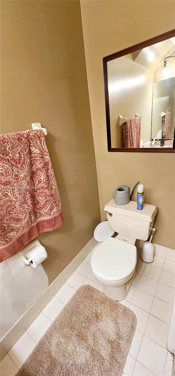 bathroom featuring tile patterned flooring and toilet