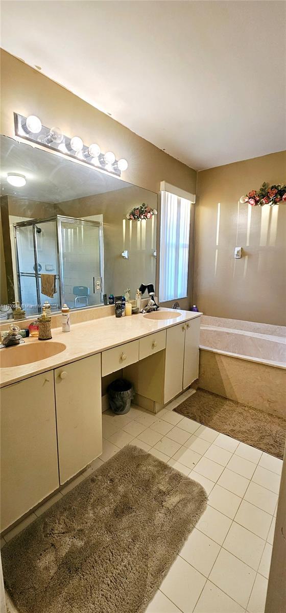 17352 SW 18th St, Miramar, FL 33029 - bathroom featuring double vanity, a garden tub, tile patterned floors, and an enclosed shower