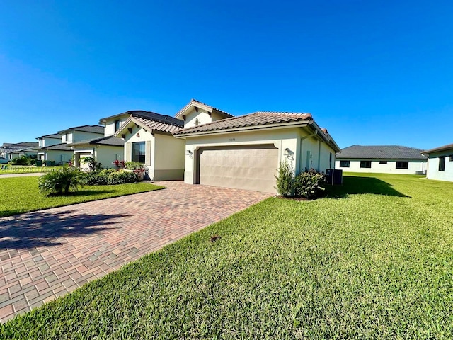 view of front of property featuring a garage and a front lawn