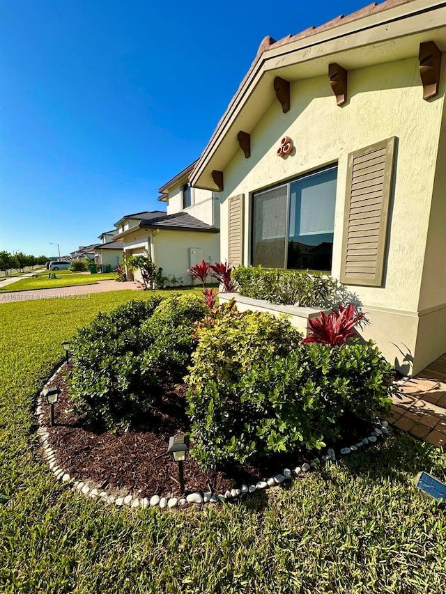 view of side of home featuring a lawn