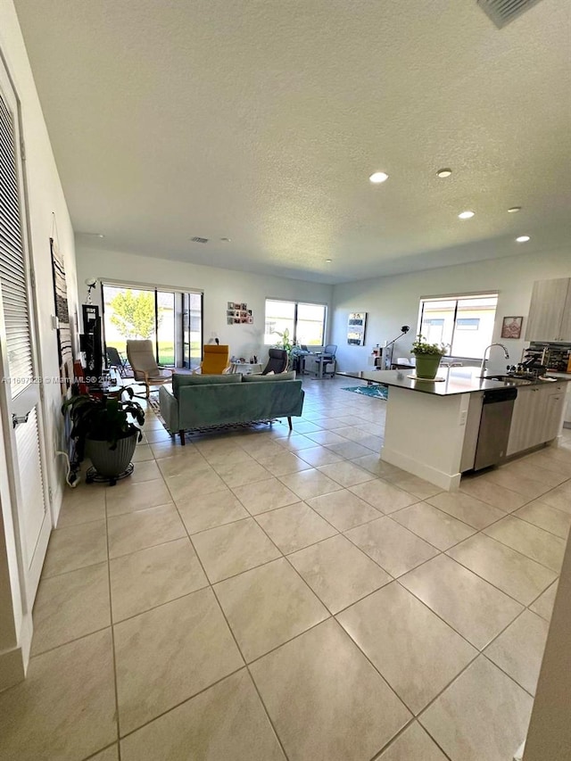 tiled living room featuring a textured ceiling