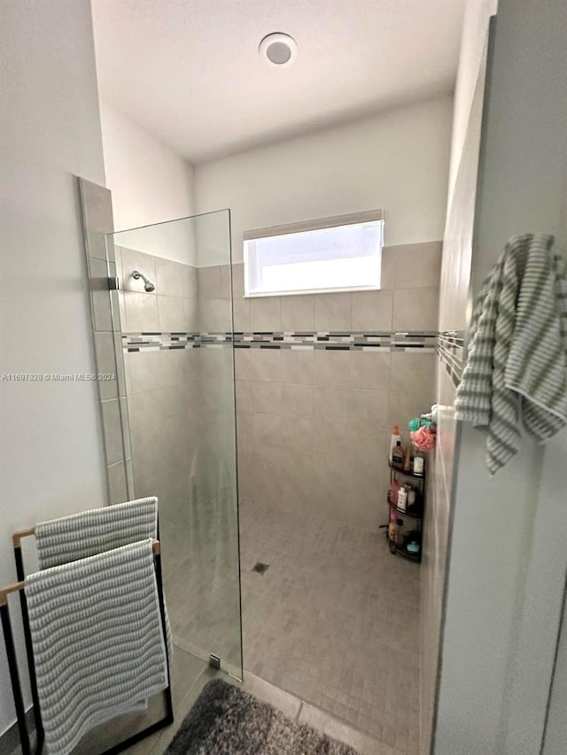 bathroom with tiled shower