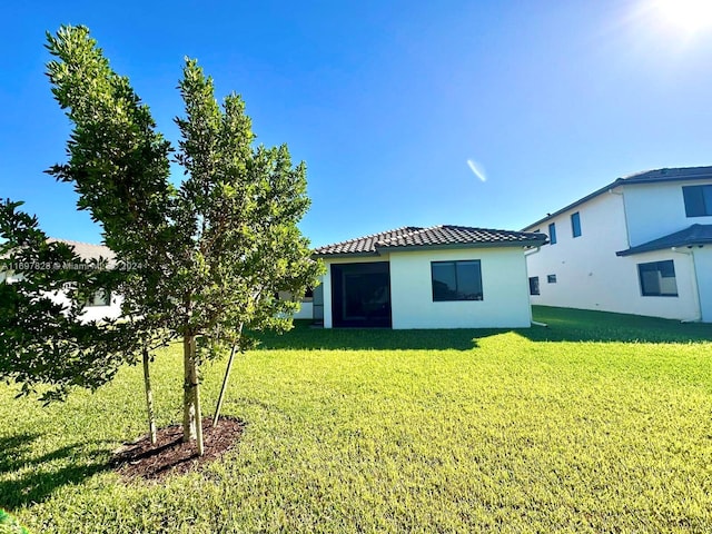 back of house with a lawn