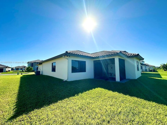 back of property featuring a lawn