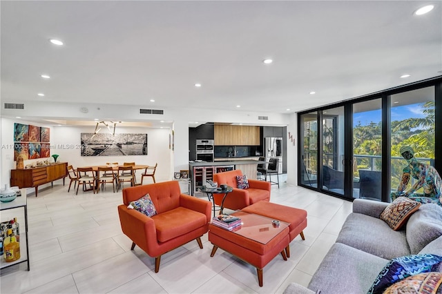 living room with expansive windows and sink