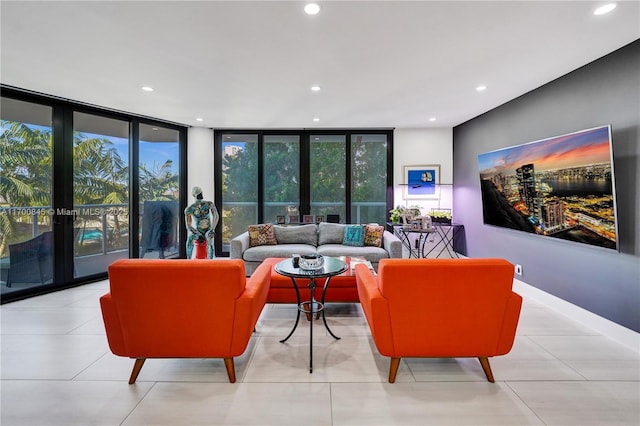 living room with a healthy amount of sunlight, a wall of windows, and french doors