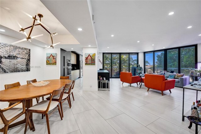 tiled dining room featuring floor to ceiling windows and a wealth of natural light