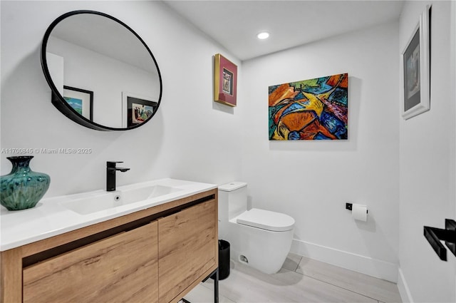 bathroom featuring vanity and toilet