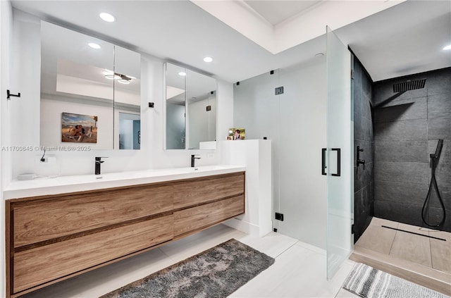 bathroom featuring vanity, tile patterned floors, and walk in shower