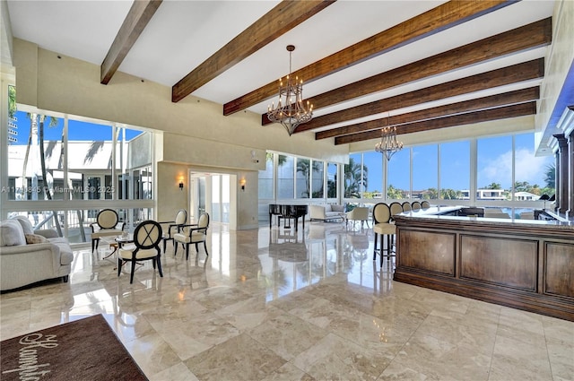 living room featuring beamed ceiling and a notable chandelier