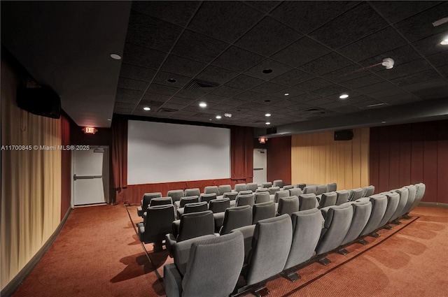 carpeted home theater with wooden walls