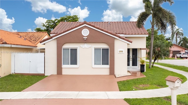 mediterranean / spanish-style home with a front lawn