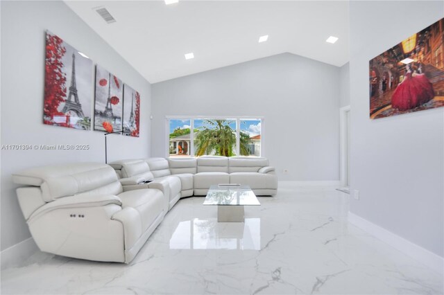 living room with high vaulted ceiling