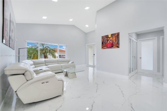 living room with high vaulted ceiling