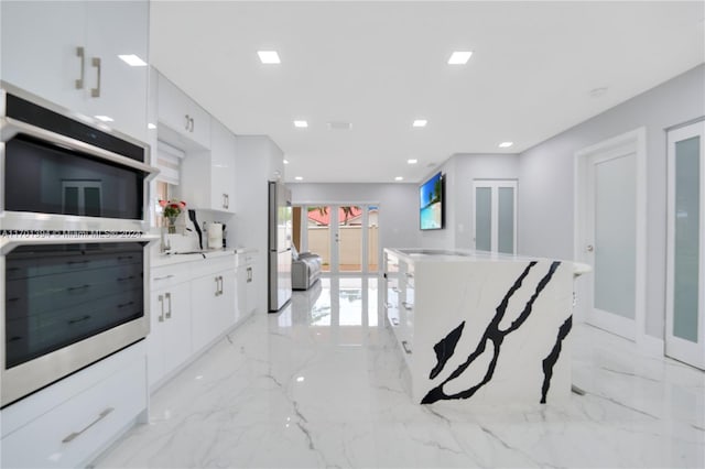 kitchen featuring white cabinetry, french doors, and appliances with stainless steel finishes