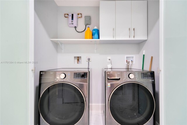 laundry area with separate washer and dryer and cabinets