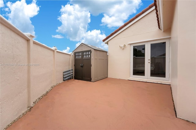 view of patio featuring french doors and a storage unit