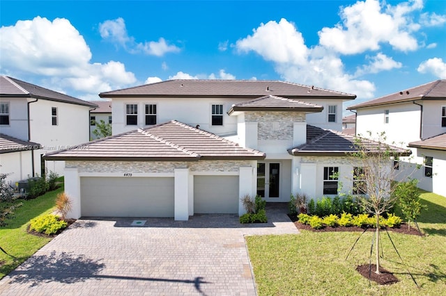 view of front of home featuring a front yard and a garage