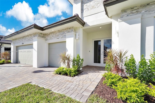 exterior space with a garage and french doors