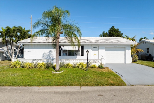 ranch-style house with a garage and a front lawn