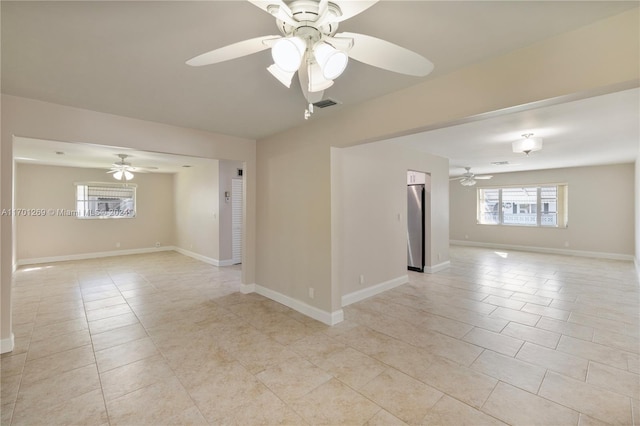 unfurnished room featuring light tile patterned floors and ceiling fan