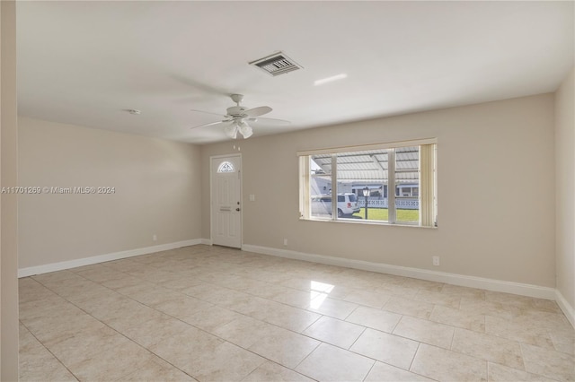 tiled empty room with ceiling fan