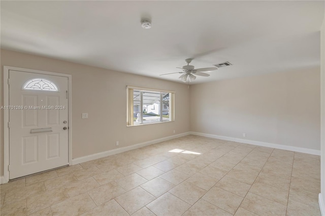 foyer with light tile patterned floors and ceiling fan