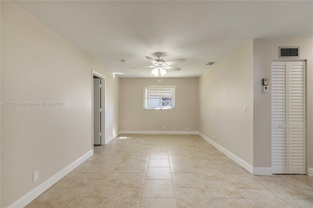 empty room featuring ceiling fan and light tile patterned floors