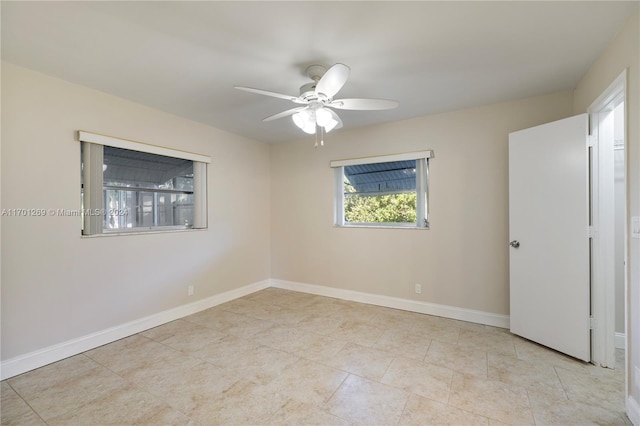 tiled spare room featuring ceiling fan