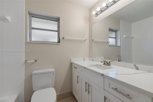 bathroom with tile patterned flooring, vanity, and toilet