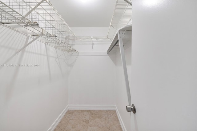 walk in closet with tile patterned flooring