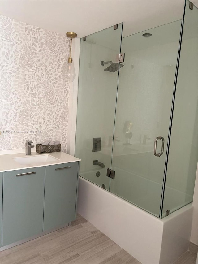 1300 Brickell Bay Dr Unit 604, Miami, FL 33131 - full bathroom with vanity, bath / shower combo with glass door, and wood finished floors