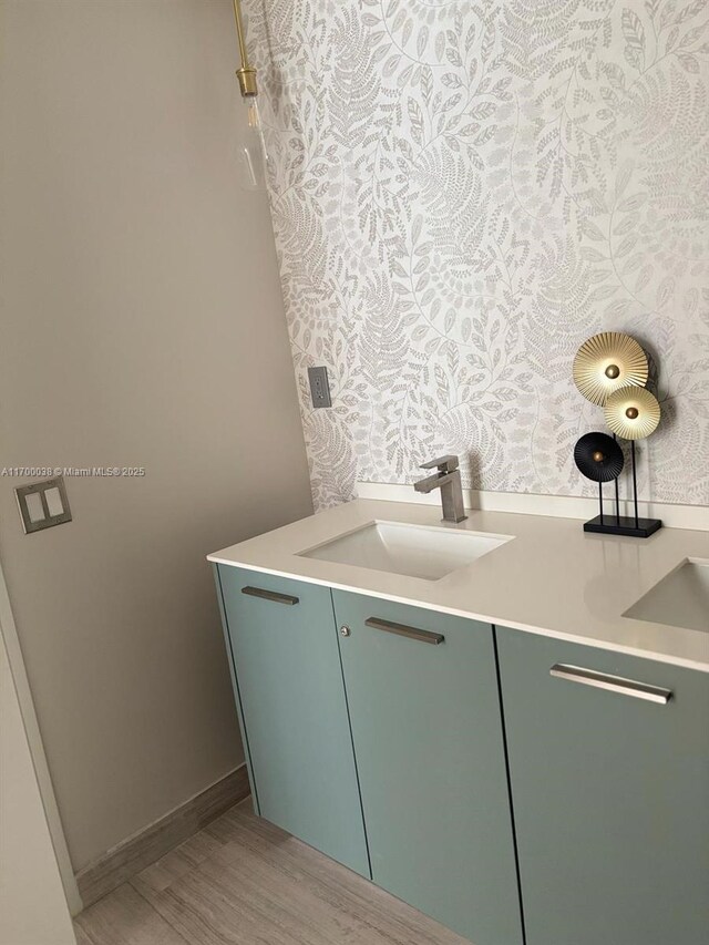 1300 Brickell Bay Dr Unit 604, Miami, FL 33131 - bathroom with wood finished floors, vanity, and wallpapered walls