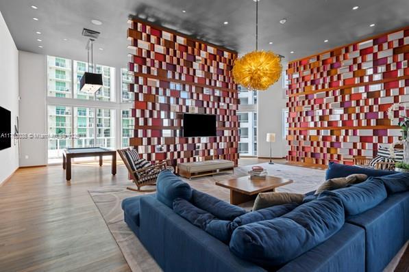 1300 Brickell Bay Dr Unit 604, Miami, FL 33131 - living room featuring wood finished floors, recessed lighting, a towering ceiling, and expansive windows