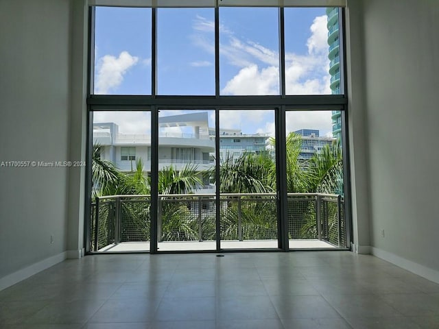 unfurnished room featuring expansive windows