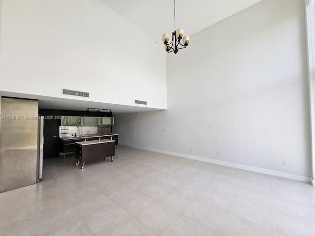 interior space with high vaulted ceiling, decorative light fixtures, and a notable chandelier