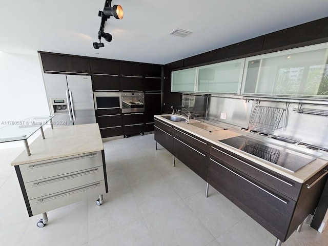 kitchen featuring a center island with sink, sink, and appliances with stainless steel finishes