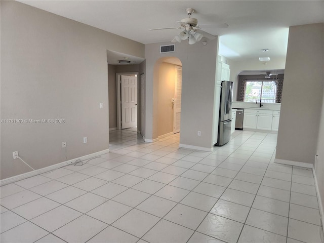 tiled spare room with ceiling fan and sink