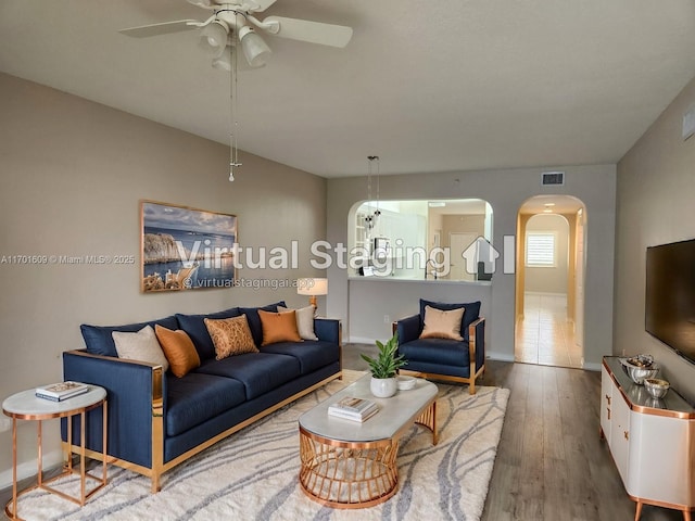 living room with ceiling fan and hardwood / wood-style floors