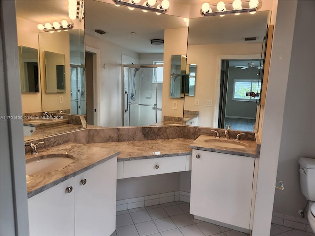 bathroom featuring tile patterned flooring, an enclosed shower, ceiling fan, toilet, and vanity