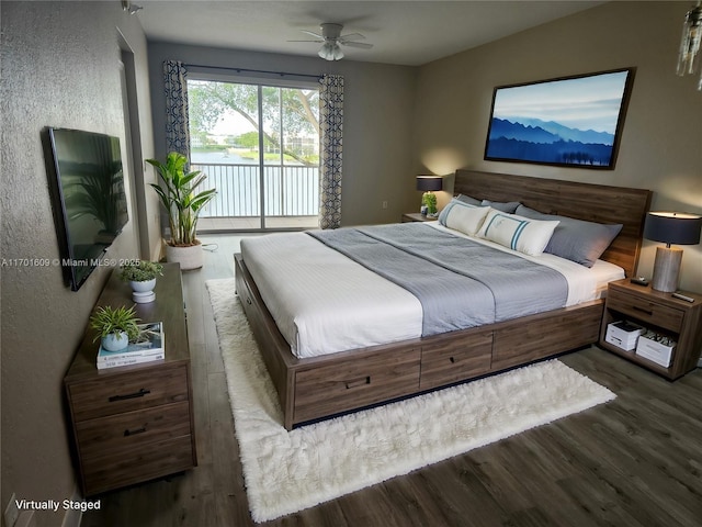 bedroom featuring dark hardwood / wood-style floors, ceiling fan, and access to outside