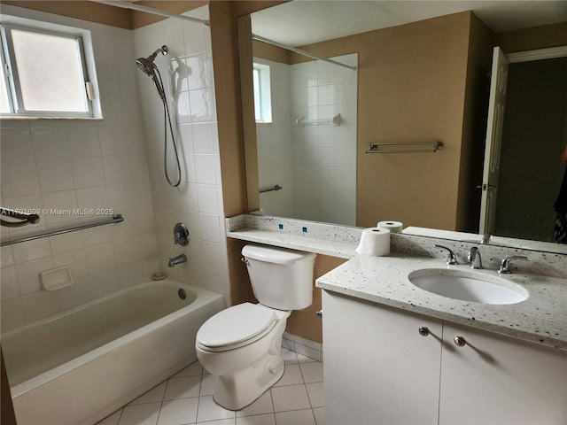 full bathroom featuring tiled shower / bath combo, toilet, tile patterned flooring, and vanity