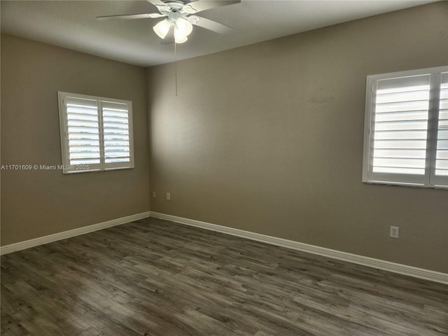 empty room with dark hardwood / wood-style floors and ceiling fan