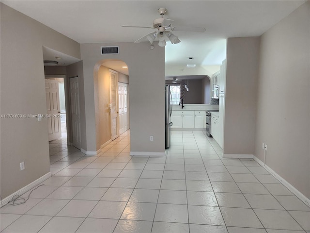 tiled empty room with ceiling fan