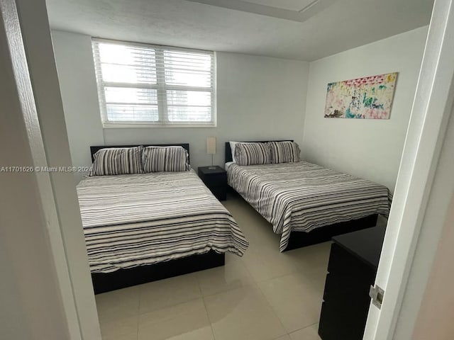 bedroom with light tile patterned floors