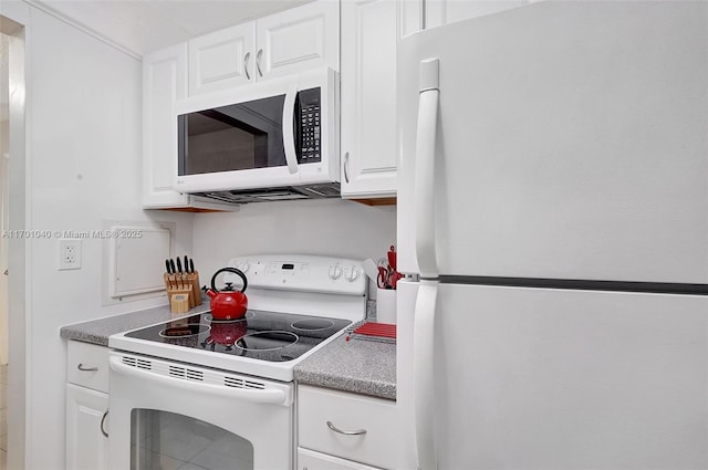 kitchen featuring white appliances and white cabinets